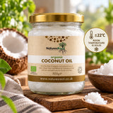 Natures Root organic coconut oil set solid below 22°C, beside a halved coconut