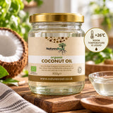 Natures Root organic coconut oil in liquid form above 26°C, with fresh coconut halves