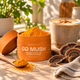 Open jar of GoMush® Turkey Tail Mushroom Extract Powder with orange powder and a wooden spoon