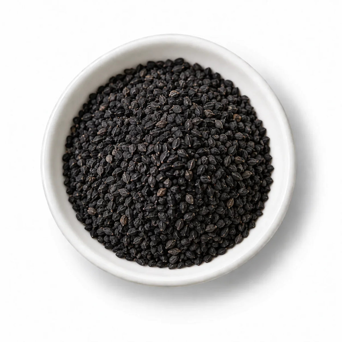 Nigella-Sativa-Samen (Schwarzkümmel) in einer weißen Schale